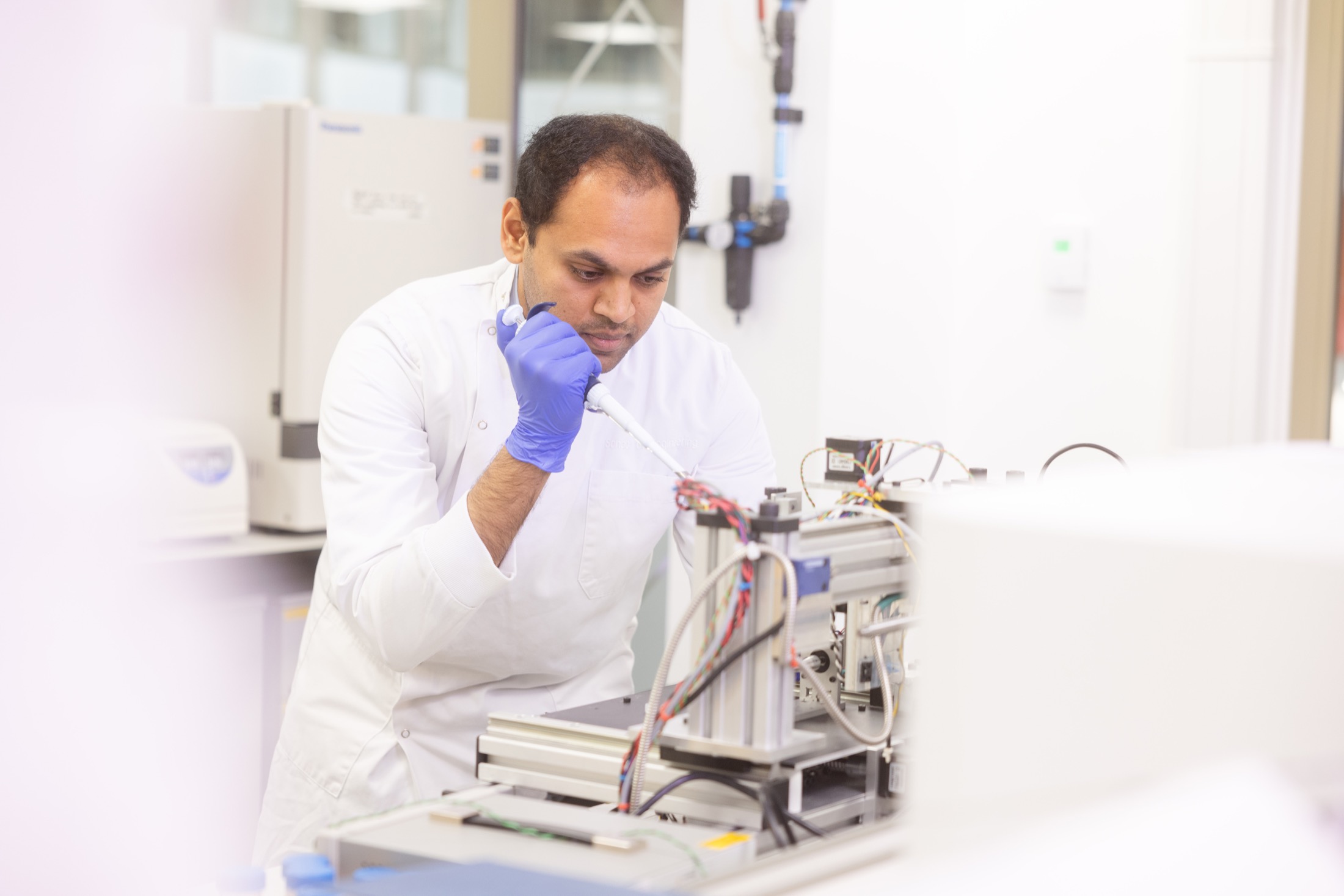 Researcher working with a JetBio system in a laboratory
